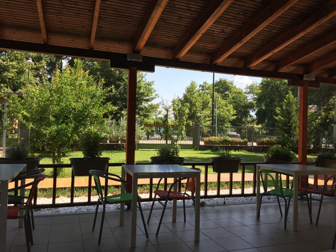 The covered breakfast patio with wooden beams looking onto the garden